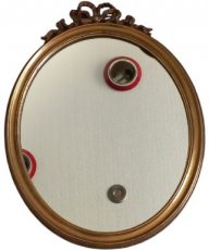oval mirror with bow motif.